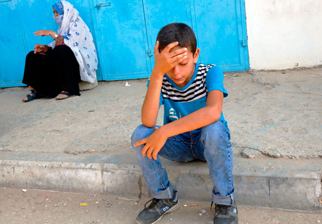 A friend of Palestinian Nasser Mosabih, 12, who was killed during a protest along the Israel-Gaza border fence, mourns during his funeral in Khan Younis, in the southern Gaza Strip, on Saturday (AFP photo)