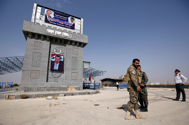 Syrian army soldiers are seen at the Nasib border crossing with Jordan in Deraa, Syria, on Monday (Reuters photo)