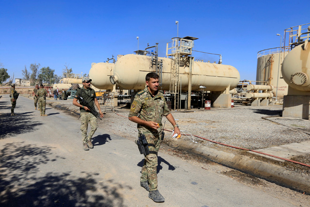 Members of Iraqi security forces are seen at an oilfield in Dibis area on the outskirts of Kirkuk, Iraq, on October 17  (Reuters photo)