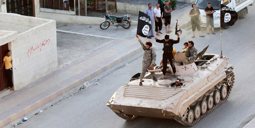 Militants take part in a military parade along the streets of northern Raqqa province on June 30, 2014 (Reuters photo)