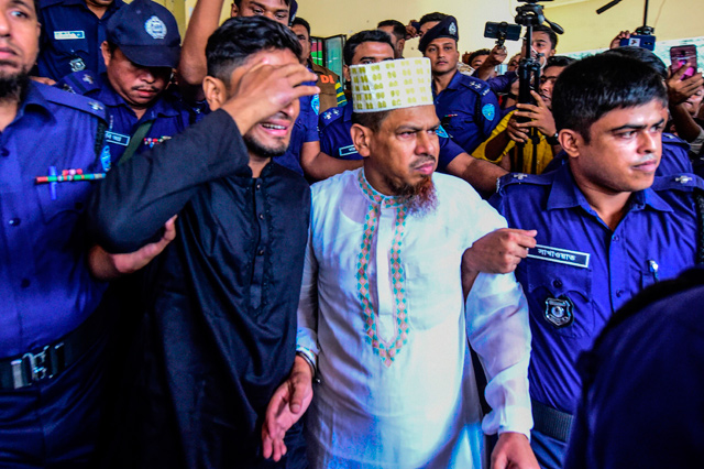 School headmaster and main suspect Siraj Ud Doula (centre) is escorted as he leaves the court following a verdict that sentenced 16 people to death over the murder of a 19-year-old female student in Feni on Thursday  (AFP photo)