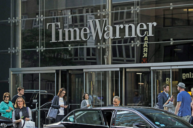 People walk past the Time Warner Centre in New York City on Tuesday (AFP photo)