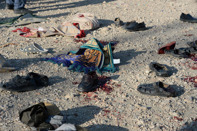 Belongings of blast victims lay in the ground at the scene of a suicide attack that targeted a funeral ceremony in Jalalabad on Sunday (AFP photo)