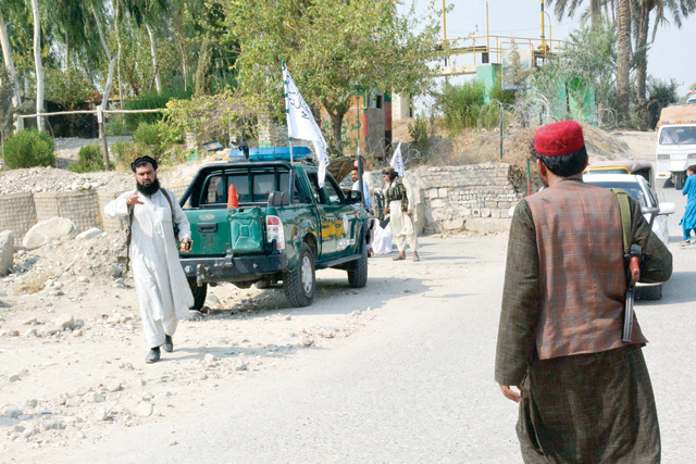 Taliban members inspect near the site of a blast in Jalalabad on Saturday (AFP photo)