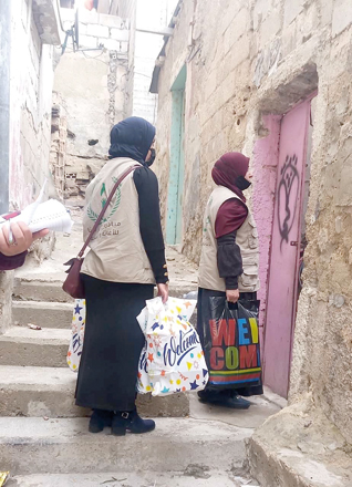 Volunteers from the Charity, Development and Relief initiative distribute donations as part of the winter campaign (Photo courtesy of the Charity, Development and Relief initiative)