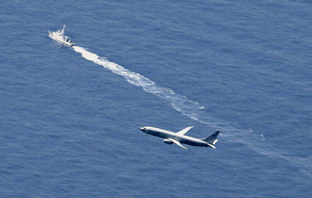 A Japan coast guard vessel and a US military aircraft conduct rescue and search operations at the site where an Air Self-Defence Force’s F-35A stealth fighter jet crashed during an exercise on Tuesday, off Aomori prefecture, Japan, in this photo taken by Kyodoon on Wednesday  (Reuters photo)