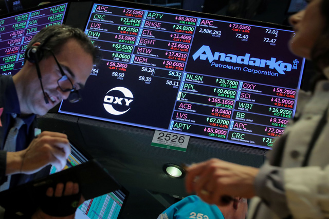 Traders work on the floor by the post that trades Anadarko Petroleum and Occidental Petroleum at the New York Stock Exchange in New York, US, on Tuesday (Reuters photo)