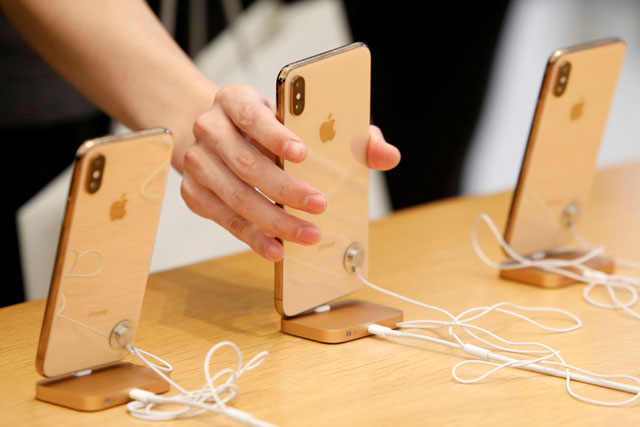 People look at iPhones at the World Trade Centre Apple Store during a Black Friday sales event in Manhattan, New York City, US, on Friday  (Reuters photo)