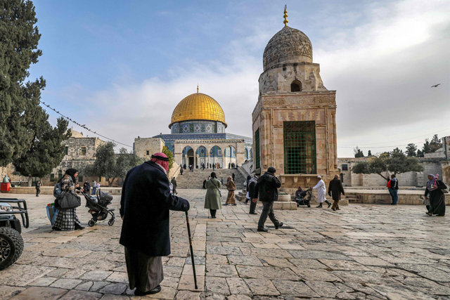 A man walks near the Dome of the Rock shrine at the Aqsa Mosque compound in Jerusalem on Tuesday (AFP photo)
