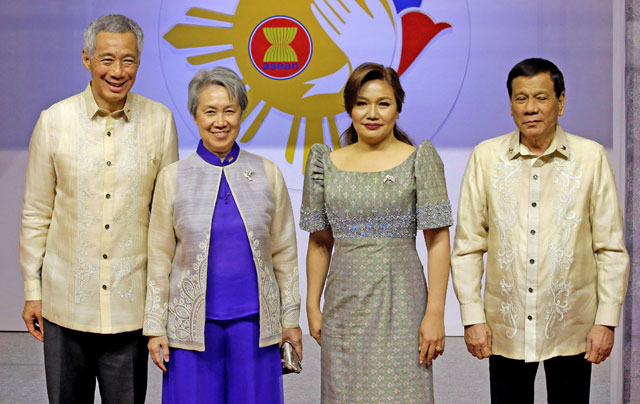 Philippine President Rodrigo Duterte and his partner Cielito Avancena pose with Singapore’s Prime Minister Lee Hsien Loong and his wife before the start of the Special Gala Celebration of the 50th Anniversary of ASEAN in Manila, Philippines, on Sunday (Reuters photo)