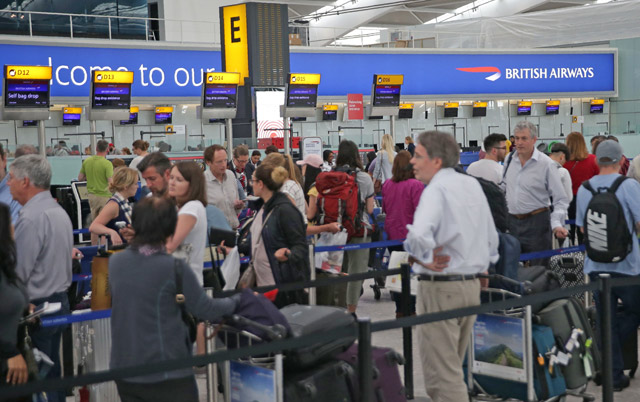 Passengers arrive with their luggage in Terminal 5 of London’s Heathrow Airport on Monday (AFP photo)