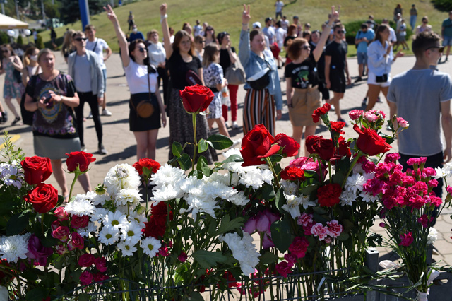 People gesture during a gathering at the site where a protester died last night in Minsk on Tuesday  (AFP photo)