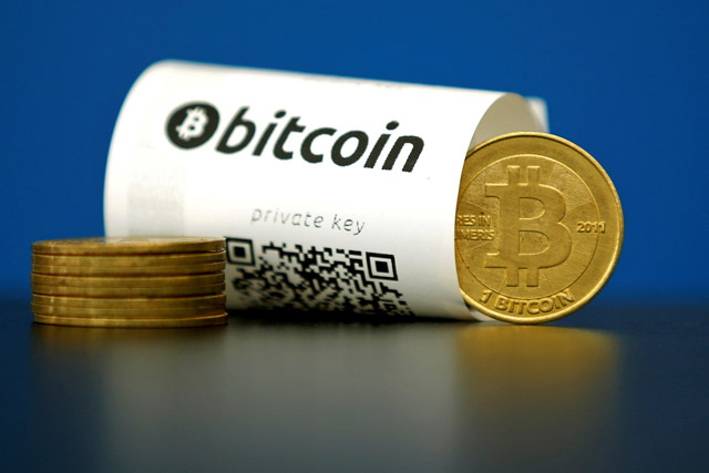 A Bitcoin (virtual currency) paper wallet with QR codes and a coin are seen in an illustration picture taken at La Maison du Bitcoin in Paris, France, on May 27, 2015 (Reuters file photo)