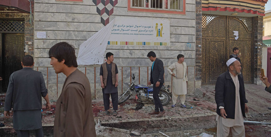  Afghan residents inspect the site of a suicide bombing outside a voter registration centre in Kabul on Sunday (AFP photo)  