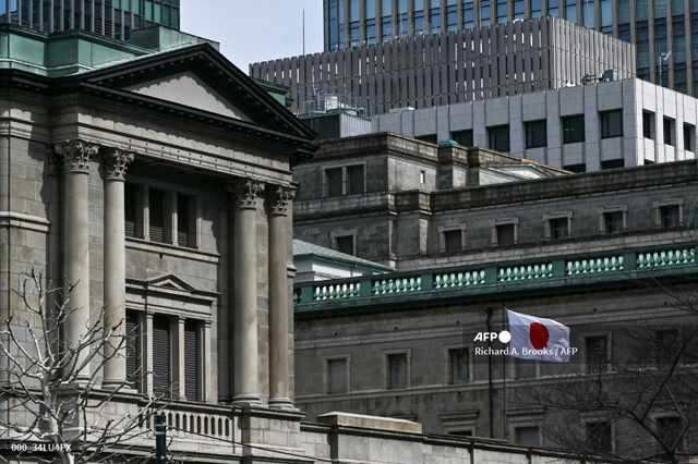 The Japanese flag flies over part of the Bank of Japan (BoJ) headquarters complex in central Tokyo on Tuesday (AFP file photo)