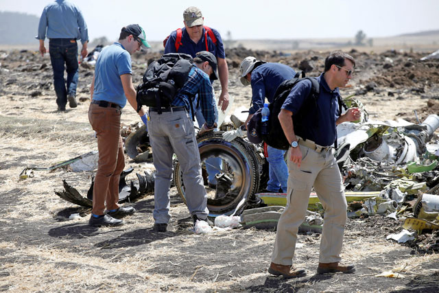 American civil aviation and Boeing investigators search through the debris at the scene of the Ethiopian Airlines Flight ET 302 plane crash, near the town of Bishoftu, southeast of Addis Ababa, Ethiopia, on Tuesday (Reuters photo) 