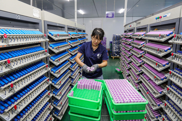 An employee works at a company manufacturing lithium batteries in Huaibei, in eastern China's Anhui province on Tuesday. China OUT  (AFP photo)