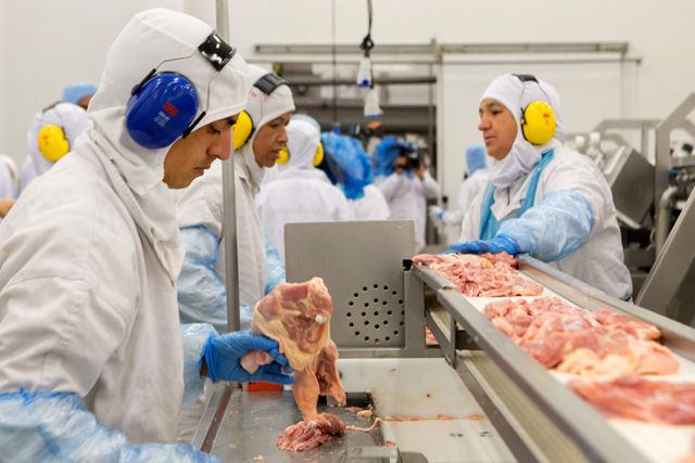 People work at a production line of the JBS-Friboi chicken processing plant during an inspection visit from Brazilian Agriculture Minister Blairo Maggi and technicians of the ministry in Lapa, Parana State, Brazil, on Tuesday (AFP photo)