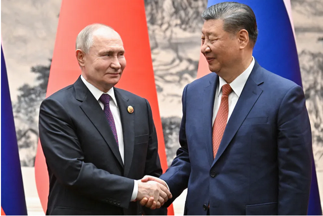 Russian President Vladimir Putin (left) and Chinese President Xi Jinping shake hands during a signing ceremony following their talks in Beijing on May 16  (AFP photo)