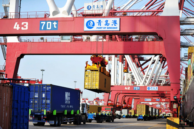 Containers are transferred at the port in Qingdao in China's eastern Shandong province, on Tuesday (AFP photo)