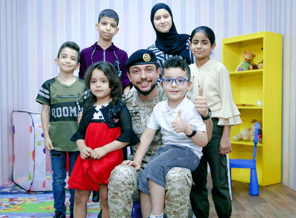 HRH Crown Prince Hussein with beneficiaries of the Hearing Without Borders initiative, which aims to provide medical support to people with hearing impairments in Jordan through cochlear implants, covering the costs of the operation and post-operative exams as well as securing the batteries and parts needed to operate the implants (Photo courtesy of Crown Prince Foundation)