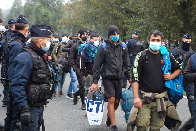French police evacuate some 800 migrants after they dismantled their camp located near the hospital in Calais, northern France, on Tuesday (AFP photo)