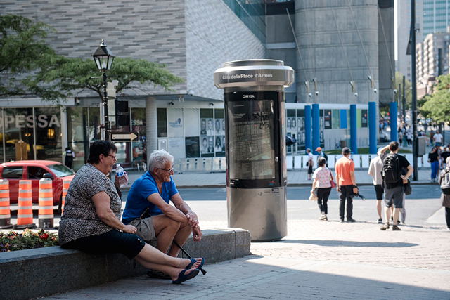 Two people relax in the shade during a heatwave in Montreal, Quebec, Canada (AFP file photo)