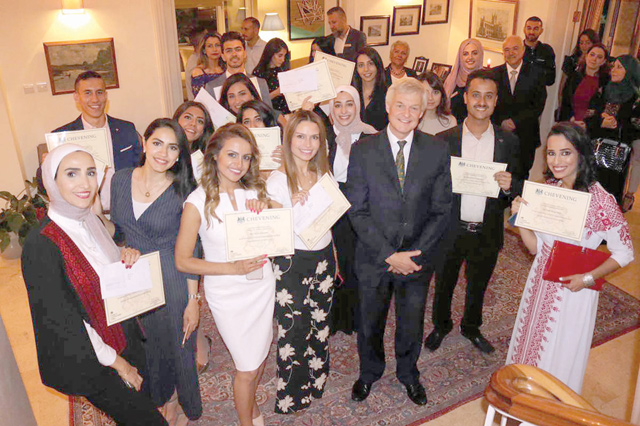 Chevening scholarship recipients pose for a photo with British Ambassador Edward Oakden at his residence on Tuesday (Petra photo)
