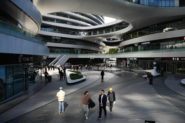 People walk in a quiet shopping mall in Beijing on November 3, 2024. (AFP file photo)