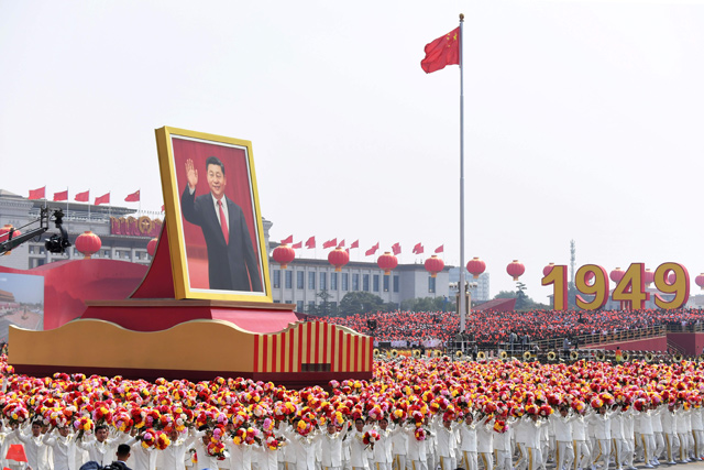 A float with a giant portrait of China's President Xi Jinping passes by Tiananmen Square during the National Day parade in Beijing, on Tuesday, to mark the 70th anniversary of the founding of the People's Republic of China (AFP photo)