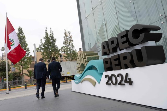 People walk by the entrance of the Lima Convention Center, part of the government complex where the Asia-Pacific Economic Cooperation (APEC) Summit will take place, in Lima on November 11, 2024 (AFP photo)