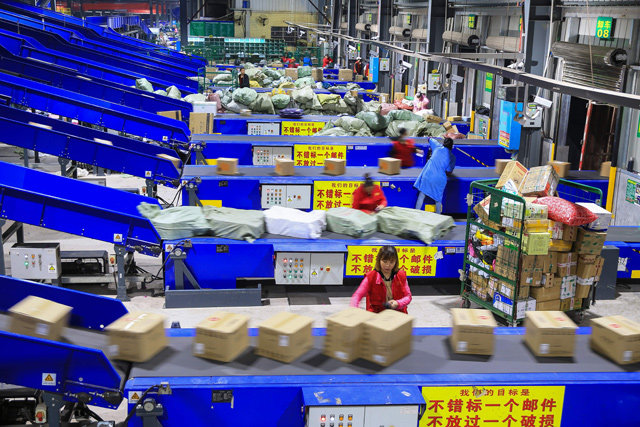 Workers sort out packages at a delivery company a day after ‘Singles' Day’ — the world's biggest 24-hour shopping event — in Hengyang in China's central Hunan province early on Tuesday   (AFP photo)