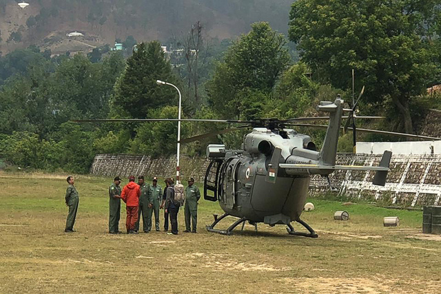 Rescue mission team members stand next to an Indian Air Force  helicopter before take-off at the Indo-Tibetan Border Police camp in Pithoragarh, in the northern Indian state of Uttarakhand, on Monday (AFP photo)