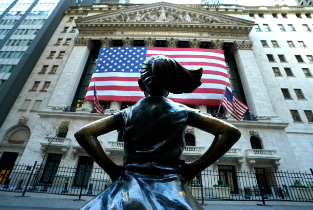 The Fearless Girl a bronze sculpture by Kristen Visbal, stands across from the New York Stock Exchange (NYSE) building in the Financial District in New York City on Wednesday (AFP photo)
