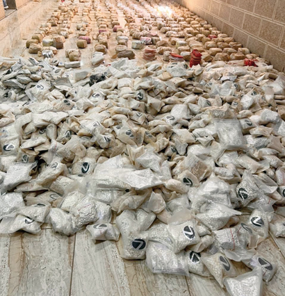 A large cache of drugs displayed by the authorities following a raid in Zarqa's Halabat region on Wednesday (Petra photo)