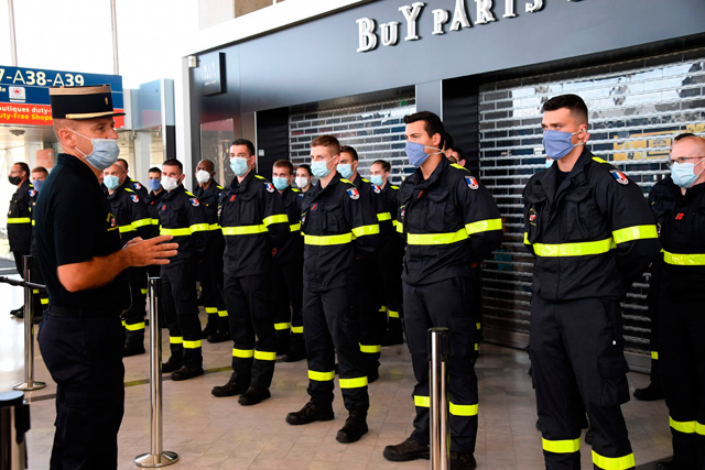 French Colonel Stanislas Rouqueyrol (left) delivers a speech to personnel of French Civil Security at Roissy Airport, near Paris, on Wednesday, as France sends three planes with search and rescue personnel and medical equipment to Beirut   (AFP photo)