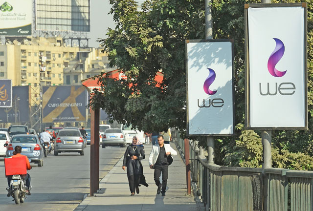 This photo taken on October 31 shows advertising billboards in Cairo for ‘WE’ a new mobile service from Egypt’s state-owned company Telecom Egypt (AFP photo)