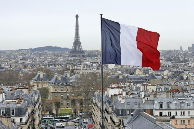 A city view shows the French flag above the skyline of the French capital as the Eiffel Tower and roof tops are seen in Paris, France, March 30, 2016 (Reuters photo)