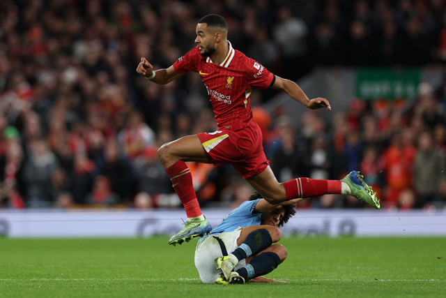 Liverpool's Dutch striker #18 Cody Gakpo jumps over Manchester City's English defender #82 Rico Lewis during the English Premier League football match between Liverpool and Manchester City at Anfield in Liverpool, north west England, on Sunday (AFP photo)