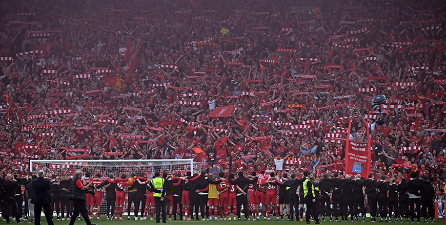 Players celebrate in front of the Liverpool fans after the English Premier League football match between Liverpool and Tottenham Hotspur at Anfield in Liverpool, north west England, on Sunday  (AFP photo)