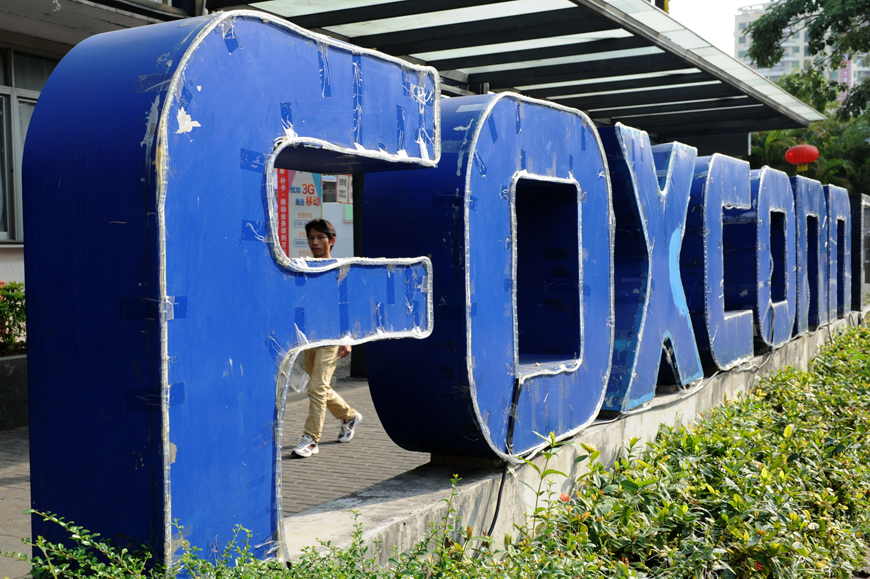 This file photo taken on February 22, 2013 shows a person walking past a Foxconn recruitment point in Shenzhen, south China's Guangdong province. (AFP photo)