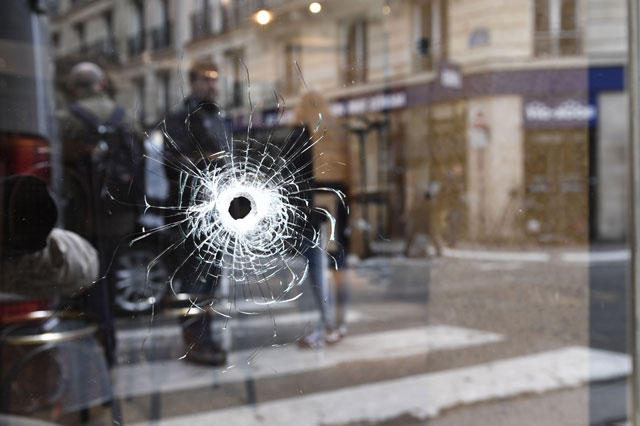 A bullet hole, seen in the window of a cafe located at the crossroads between the streets Saint-Augustin and Monsigny, is pictured in Paris, on Sunday, the day after a knifeman killed one man and wounded four other people  (AFP photo)