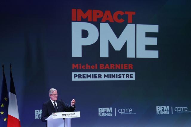 French Prime Minister Michel Barnier addresses a speech at the 5th Impact PME (small and medium businesses) event, at the Station F, a business incubator, in Paris on Thursday  (AFP photo)