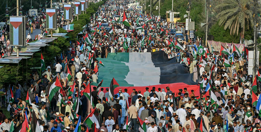 Supporters of Pakistan's Jamaat-e-Islami (JI) Party hold flags and placards as they march to show solidarity with Palestinians amid the ongoing conflict, in Karachi on Sunday (AFP photo)