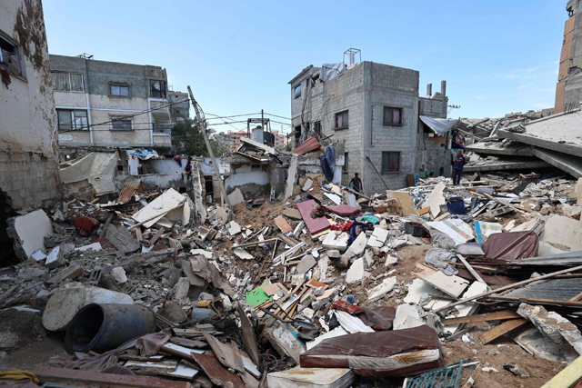 Palestinians inspect the damage following overnight Israeli strikes, at the Nuseirat refugee camp in the central Gaza Strip on May 4, 2025 (AFP photo)