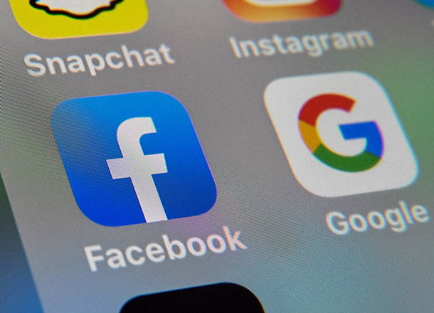 The logos of mobile apps Facebook and Google are displayed on a tablet in Lille on October 1, 2019 (AFP photo)