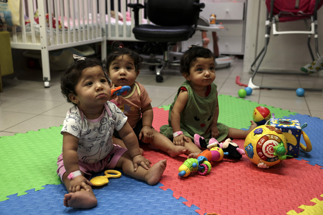 Palestinian triplets of Gaza-native Hanane Bayouk, Najmeh (left), Najoua (centre) and Noor, play at the children's ward of the Al Maqased Hospital in east Jerusalem on July 31 (AFP photo)