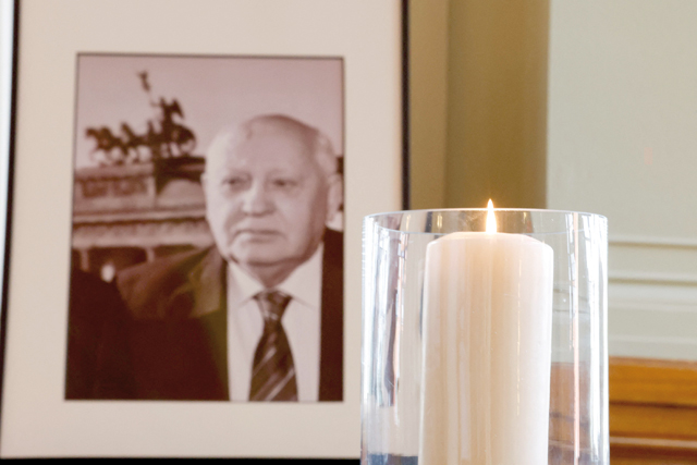 A candle burns next to a photo of late former Soviet leader Mikhail Gorbachev at the City Hall in Berlin, on Thursday (AFP photo)