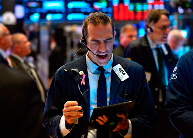 Traders work after the opening bell at the New York Stock Exchange, on Thursday, at Wall Street in New York City  (AFP photo)