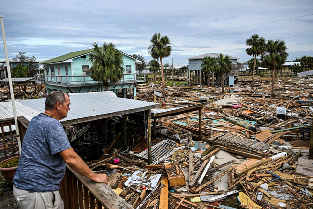 David Hester inspects damages of his house after Hurricane Helene made landfall in Horseshoe Beach, Florida, on September 28 (AFP photo)